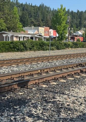 Railroad tracks running past historic downtown Colfax storefronts